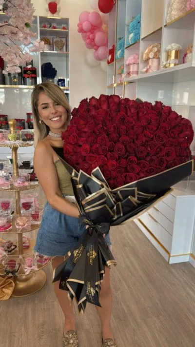 Clienta con un ramo enorme de rosas rojas